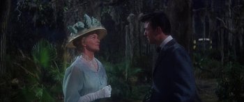 Movie still from “Summer and Smoke” (1961), directed by Peter Glenville – An older woman and a younger man talking in front of a forest; Medium shot, Over the shoulder angle