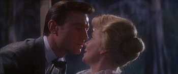 Movie still from “Summer and Smoke” (1961), directed by Peter Glenville – A man and a woman face to face in front of a wall; Close Up shot, Low angle