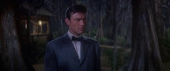 Movie still from “Summer and Smoke” (1961), directed by Peter Glenville – A person wearing a suit and bow tie; Medium shot, Low angle