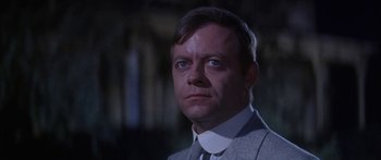 Movie still from “Summer and Smoke” (1961), directed by Peter Glenville – A person wearing a suit and tie; Close Up shot, Low angle