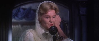 Movie still from “Summer and Smoke” (1961), directed by Peter Glenville – An older woman wearing a white dress and a white veil; Close Up shot, High angle