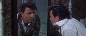 Movie still from “Summer and Smoke” (1961), directed by Peter Glenville – A man talking to another man in front of a mirror; Close Up shot, Over the shoulder angle