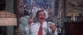 Movie still from “Summer and Smoke” (1961), directed by Peter Glenville – A man in a tie holding a pair of pistols; Medium shot, Low angle