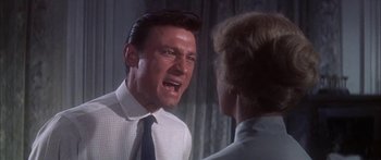 Movie still from “Summer and Smoke” (1961), directed by Peter Glenville – A man in a white dress shirt and a blue tie; Close Up shot, Low angle