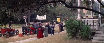 Movie still from “Summer and Smoke” (1961), directed by Peter Glenville – A group of people walking down a street; Extreme Wide shot, High angle