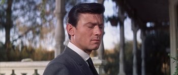 Movie still from “Summer and Smoke” (1961), directed by Peter Glenville – A person wearing a suit and tie; Close Up shot, Low angle
