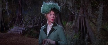 Movie still from “Summer and Smoke” (1961), directed by Peter Glenville – An older woman wearing a green coat and a green hat; Close Up shot, Over the shoulder angle