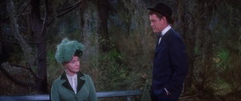 Movie still from “Summer and Smoke” (1961), directed by Peter Glenville – A man and a woman wearing hats in a forest; Medium shot, Over the shoulder angle