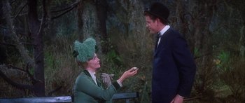 Movie still from “Summer and Smoke” (1961), directed by Peter Glenville – A man and a woman dressed in costume; Medium shot, High angle