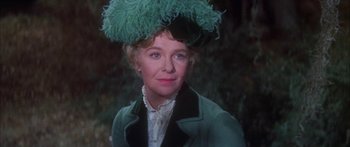 Movie still from “Summer and Smoke” (1961), directed by Peter Glenville – An older woman wearing a green hat and a green coat; Close Up shot, Over the shoulder angle