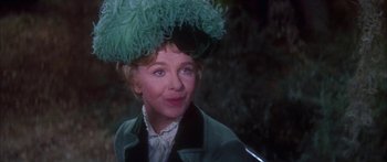 Movie still from “Summer and Smoke” (1961), directed by Peter Glenville – An older woman wearing a green hat and a jacket; Close Up shot, Over the shoulder angle