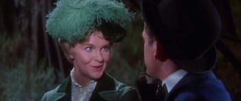 Movie still from “Summer and Smoke” (1961), directed by Peter Glenville – An older woman wearing a green hat talking to an older man; Close Up shot, Over the shoulder angle