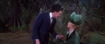 Movie still from “Summer and Smoke” (1961), directed by Peter Glenville – A man and a woman are holding hands outside; Medium shot, Over the shoulder angle