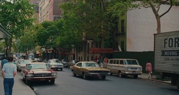 Movie still from “Taking Woodstock” (2009), directed by Ang Lee – Cars are driving down the street on a busy street; Wide shot, High angle