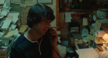 Movie still from “Taking Woodstock” (2009), directed by Ang Lee – A man talking on a phone while sitting at a desk; Close Up shot, Over the shoulder angle