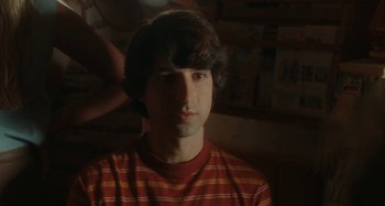 Movie still from “Taking Woodstock” (2009), directed by Ang Lee – A young man in a red and yellow striped t - shirt; Close Up shot, High angle
