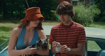 Movie still from “Taking Woodstock” (2009), directed by Ang Lee – A man and a woman with a small dog; Medium shot, High angle