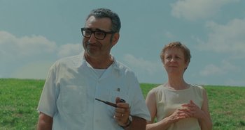 Movie still from “Taking Woodstock” (2009), directed by Ang Lee – An older man and woman standing next to each other; Medium shot, Low angle