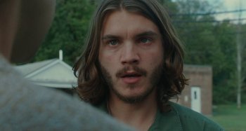 Movie still from “Taking Woodstock” (2009), directed by Ang Lee – A person with long hair and a beard; Close Up shot, Over the shoulder angle
