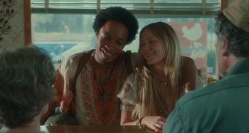 Movie still from “Taking Woodstock” (2009), directed by Ang Lee – A man and a woman sitting at a table together; Medium shot, Over the shoulder angle