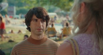 Movie still from “Taking Woodstock” (2009), directed by Ang Lee – A man and a woman are standing in front of a crowd; Close Up shot, Over the shoulder angle
