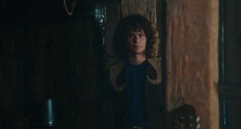Movie still from “Taking Woodstock” (2009), directed by Ang Lee – A man with curly brown hair wearing a brown jacket; Medium shot, Low angle