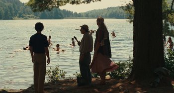 Movie still from “Taking Woodstock” (2009), directed by Ang Lee – A group of people standing on the shore of a body of water; Wide shot, Over the shoulder angle