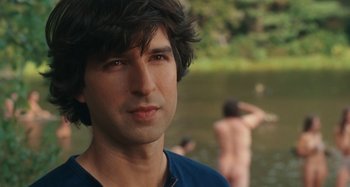 Movie still from “Taking Woodstock” (2009), directed by Ang Lee – A person near a body of water; Close Up shot, Over the shoulder angle