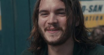 Movie still from “Taking Woodstock” (2009), directed by Ang Lee – A person with long hair and a beard; Close Up shot, Over the shoulder angle