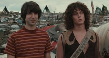Movie still from “Taking Woodstock” (2009), directed by Ang Lee – Two young men standing in the middle of a pile of trash; Medium shot, Low angle