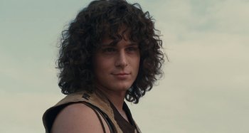 Movie still from “Taking Woodstock” (2009), directed by Ang Lee – A young man with long curly hair posing for a picture; Close Up shot, Low angle
