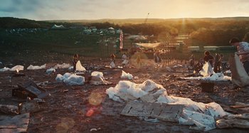 Movie still from “Taking Woodstock” (2009), directed by Ang Lee – A group of people standing on top of a field; Extreme Wide shot, High angle