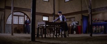 A man standing in front of a wooden table