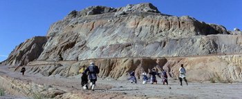 A group of people walking on a dirt road