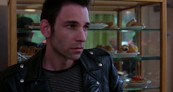 Movie still from “The Loveless” (1981), directed by Kathryn Bigelow – A person wearing a leather jacket; Close Up shot, Over the shoulder angle