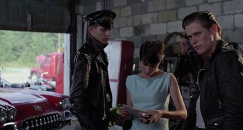 Movie still from “The Loveless” (1981), directed by Kathryn Bigelow – A man and a woman looking at a piece of paper; Medium shot, Over the shoulder angle