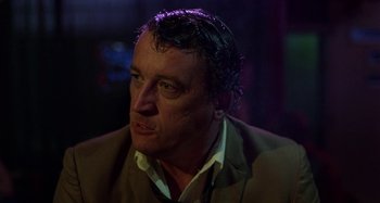 Movie still from “The Loveless” (1981), directed by Kathryn Bigelow – A person wearing a jacket; Close Up shot, Over the shoulder angle