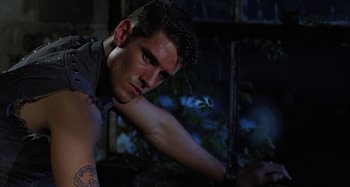 Movie still from “The Loveless” (1981), directed by Kathryn Bigelow – A person leaning on a wall; Close Up shot, Low angle