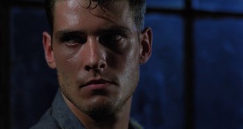 Movie still from “The Loveless” (1981), directed by Kathryn Bigelow – A man's eyes and face; Close Up shot, Low angle