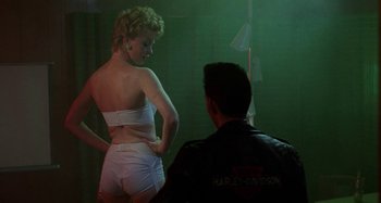 Movie still from “The Loveless” (1981), directed by Kathryn Bigelow – A man and a woman in white lingerie; Medium shot, Over the shoulder angle