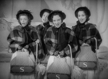 Movie still from “The Merry Widow” (1934), directed by Ernst Lubitsch – A group of four women standing next to each other; Medium shot, High angle