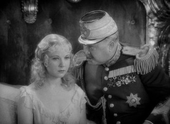 Movie still from “The Merry Widow” (1934), directed by Ernst Lubitsch – An old photo of a man and a woman; Close Up shot, Over the shoulder angle