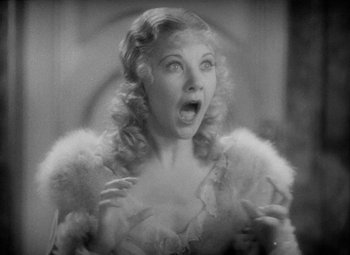 Movie still from “The Merry Widow” (1934), directed by Ernst Lubitsch – An old photo of a woman with a surprised look on her face; Close Up shot, Low angle