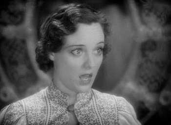 Movie still from “The Merry Widow” (1934), directed by Ernst Lubitsch – An old photo of a woman with a surprised look on her face; Close Up shot, High angle