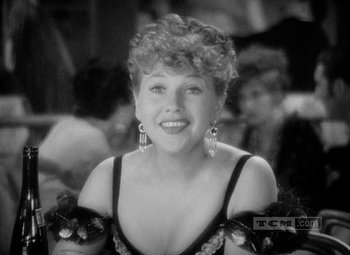 Movie still from “The Merry Widow” (1934), directed by Ernst Lubitsch – A black - and - white photo of a woman in a black dress; Close Up shot, Over the shoulder angle