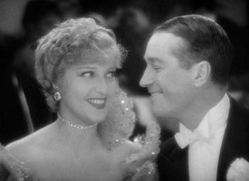 Movie still from “The Merry Widow” (1934), directed by Ernst Lubitsch – An older man and a younger woman in formal wear; Close Up shot, High angle