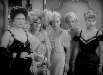 Movie still from “The Merry Widow” (1934), directed by Ernst Lubitsch – A black and white photo of a group of women in fancy dresses; Medium shot, High angle
