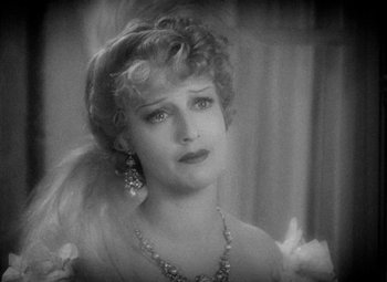 Movie still from “The Merry Widow” (1934), directed by Ernst Lubitsch – An old black and white photo of a woman; Close Up shot, High angle