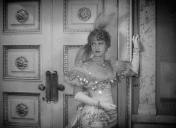 Movie still from “The Merry Widow” (1934), directed by Ernst Lubitsch – A black and white photo of a woman in a dress; Medium shot, High angle