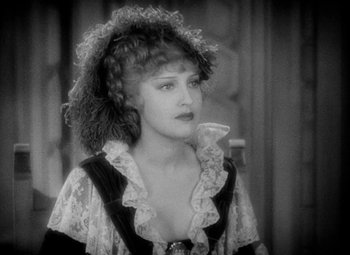 Movie still from “The Merry Widow” (1934), directed by Ernst Lubitsch – An old photo of a woman in a black and white photo; Close Up shot, Over the shoulder angle